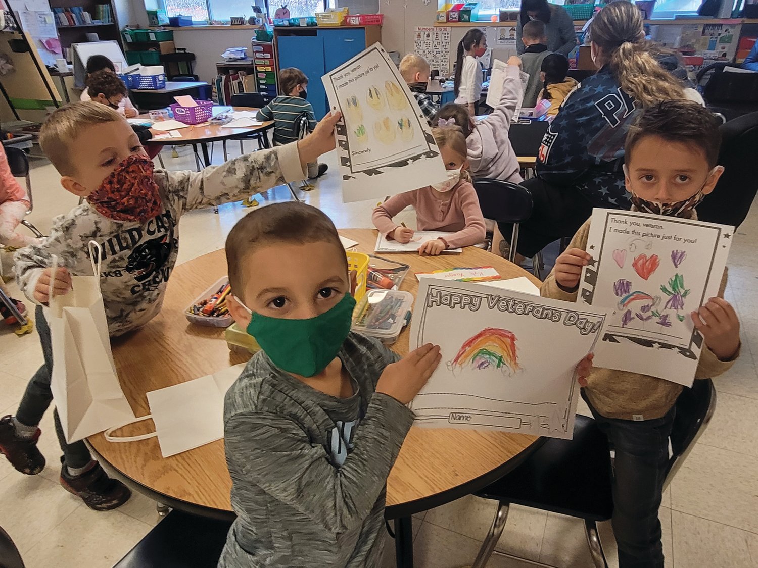 Barnes School students in Johnston first drew pictures for veterans, and then attached the drawings to bags they filled with snacks and toiletries.